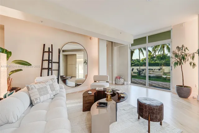 a living room with furniture and a floor to ceiling window