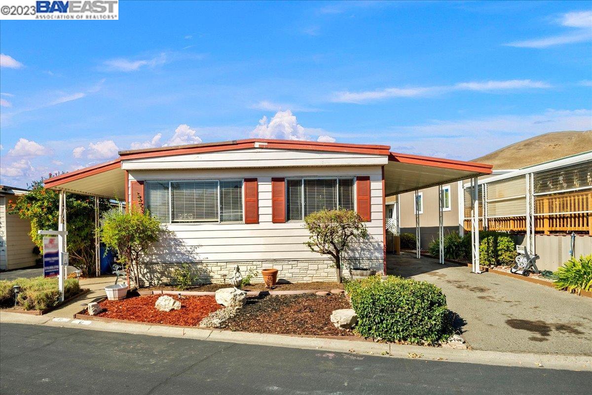 711 Old Canyon Road, Unit 52 Fremont, CA 94536 - Photo 1 of 1 a front view of a house with garden