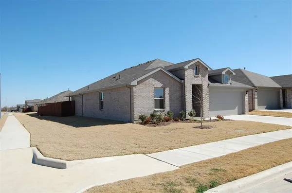 a view of a house with snow on the road