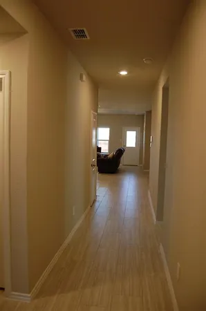 a living room with furniture a chandelier and a dining table