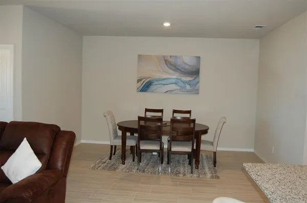 a kitchen with stainless steel appliances kitchen island granite countertop a refrigerator a stove a sink and a microwave