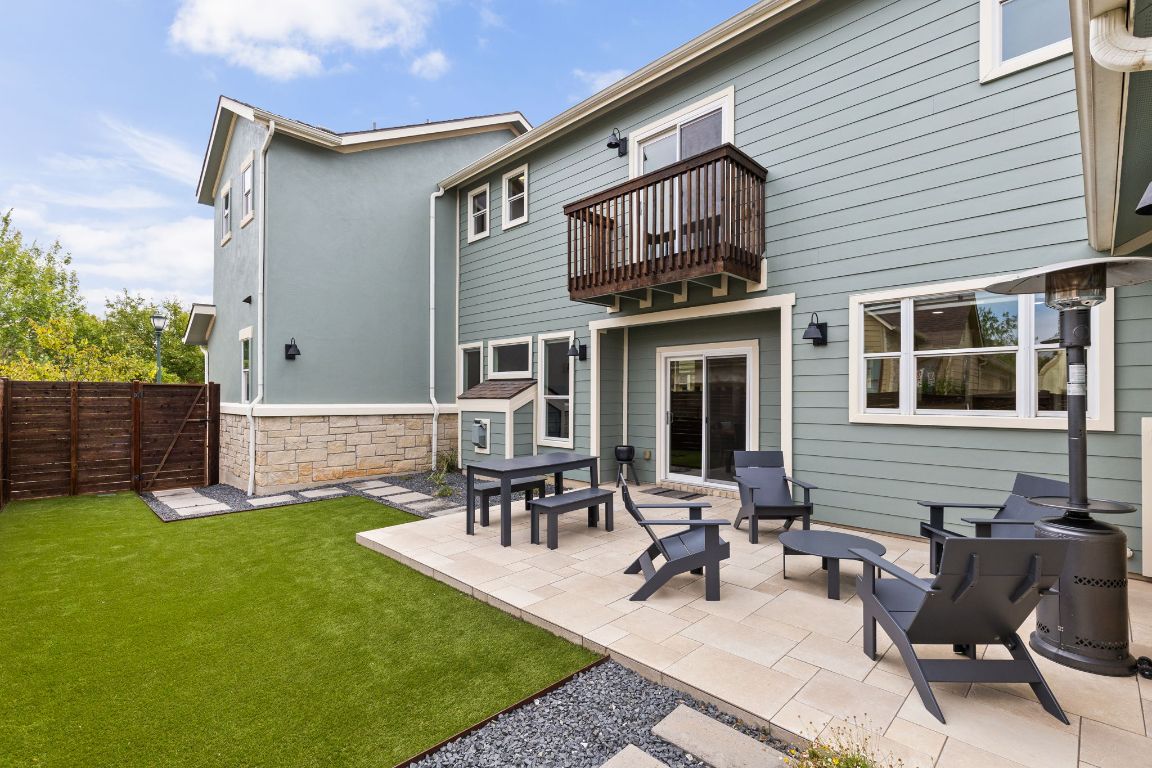 a view of a house with patio and a yard