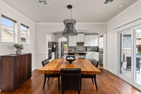 a view of a dining room with furniture and wooden floor