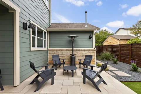 a view of a house with patio and a yard