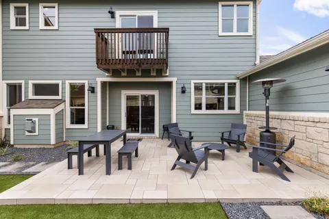 a view of a house with patio and a yard