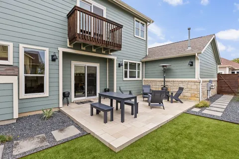 a view of a house with backyard porch and sitting area