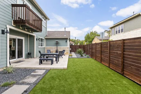 a view of a backyard with sitting area