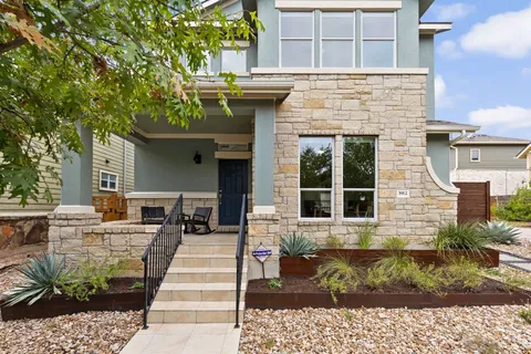 a view of a brick house with large windows