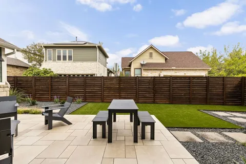 a front view of a house with yard and trees