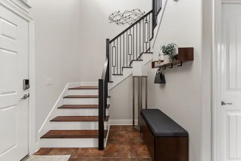 a view of entryway and hall with wooden floor