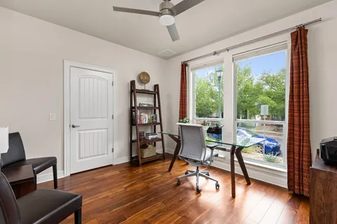 a workspace with wooden floor and a window