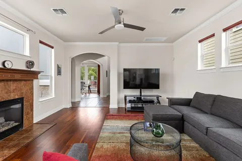 a living room with furniture a flat screen tv and a fireplace
