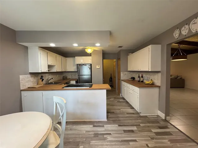 a large kitchen with a table and chairs in it