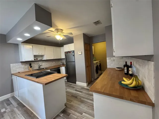 a kitchen that has a sink and cabinets