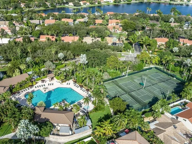 a view of house with swimming pool outdoor seating