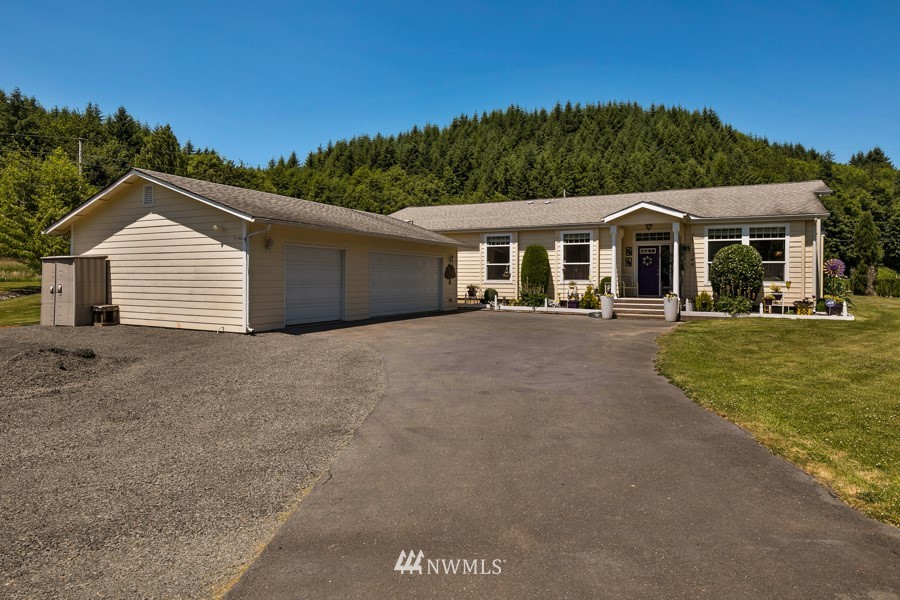 1366 Hining Road Winlock, WA 98596 - Photo 3 of 33 a front view of a house with a yard and trees