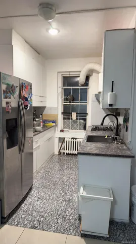 a kitchen with a sink and a stove top oven