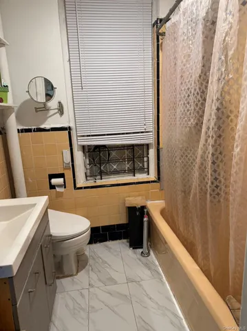 a bathroom with a sink a toilet and bathtub