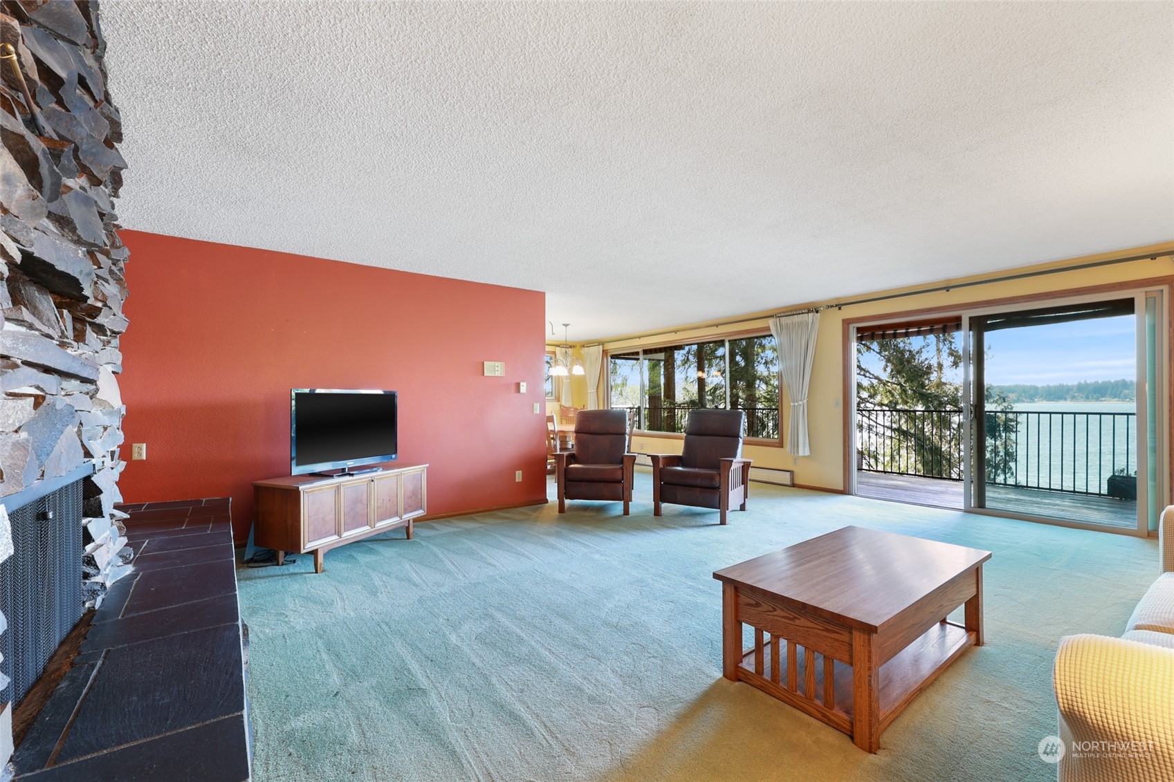 3545 Boston Harbor Road Northeast Olympia, WA 98506 - Photo 11 of 36 a living room with furniture a flat screen tv and floor to ceiling window