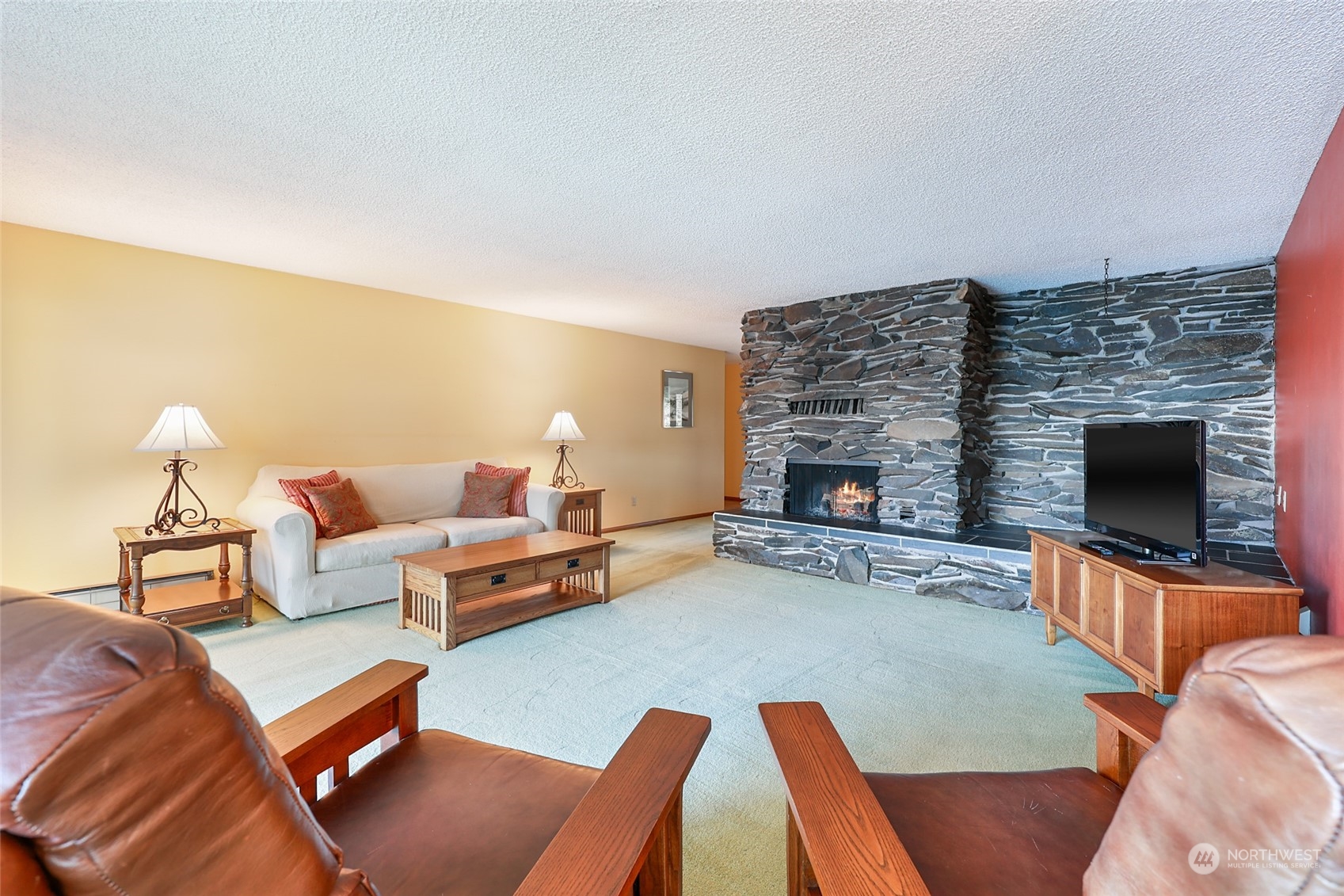 3545 Boston Harbor Road Northeast Olympia, WA 98506 - Photo 13 of 36 a living room with furniture and a fireplace