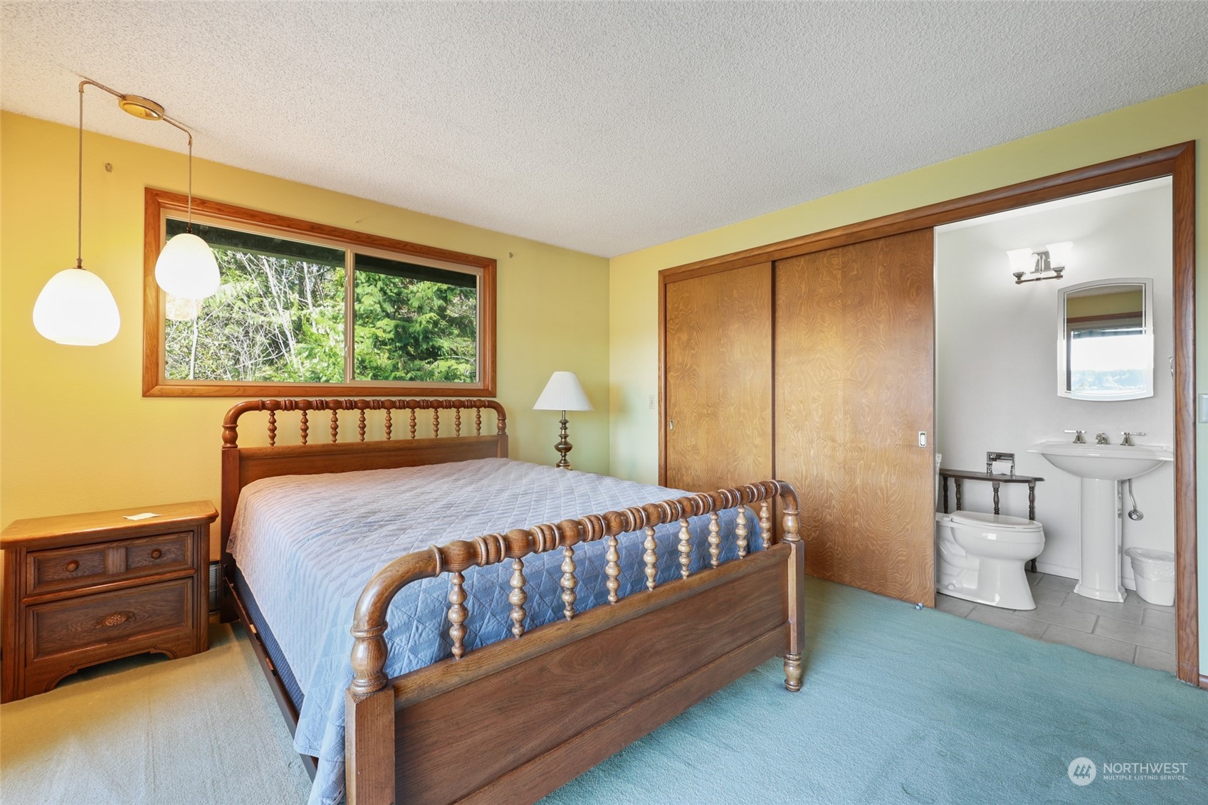 3545 Boston Harbor Road Northeast Olympia, WA 98506 - Photo 16 of 36 a bed sitting in a bedroom next to a window