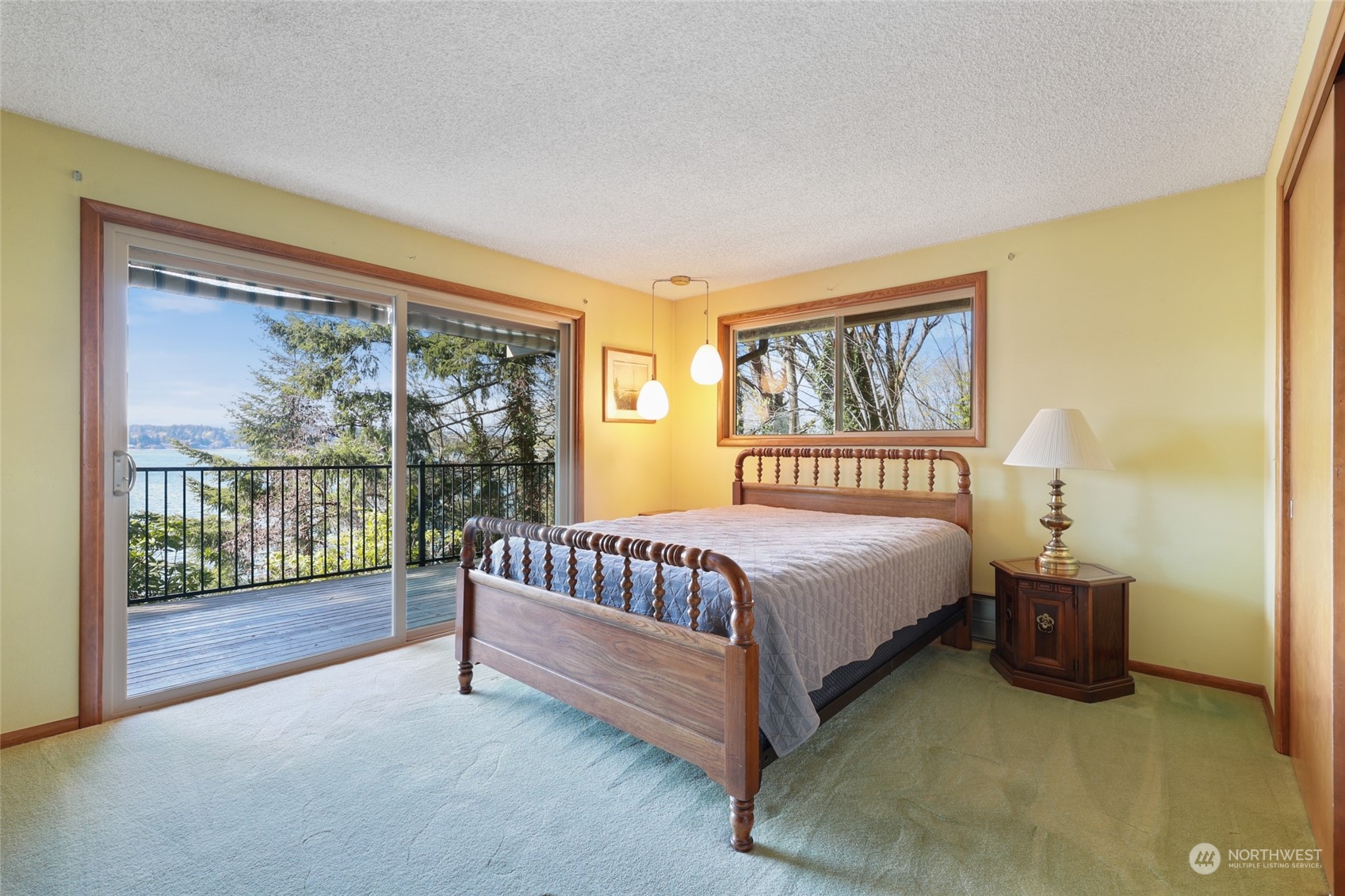 3545 Boston Harbor Road Northeast Olympia, WA 98506 - Photo 17 of 36 a spacious bedroom with a bed and a large window