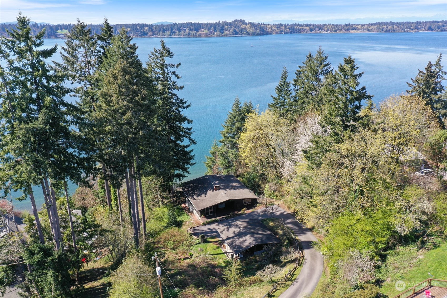 3545 Boston Harbor Road Northeast Olympia, WA 98506 - Photo 2 of 36 a backyard of a house with lots of green space and lake view