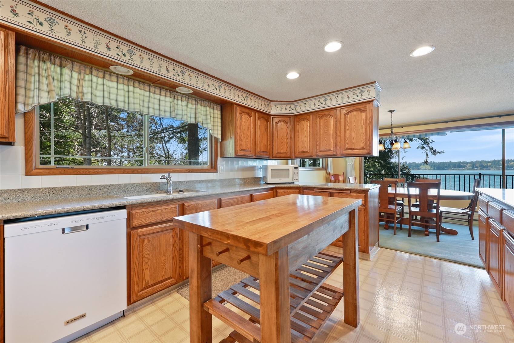 3545 Boston Harbor Road Northeast Olympia, WA 98506 - Photo 6 of 36 a kitchen with stainless steel appliances granite countertop a stove a sink and a microwave