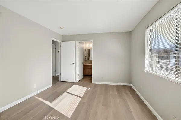 a view of a room with wooden floor and a window
