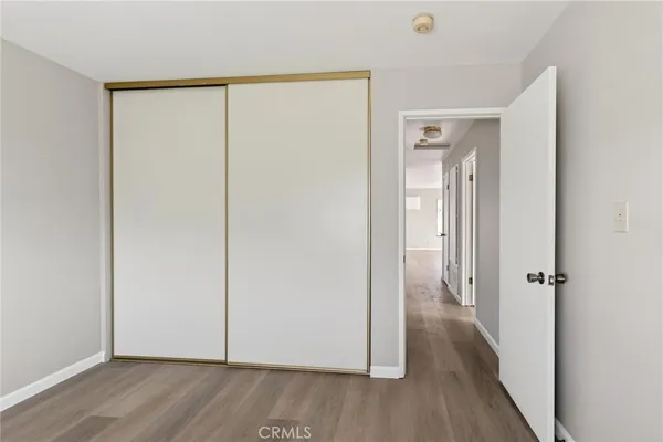 a view of a room with wooden floor