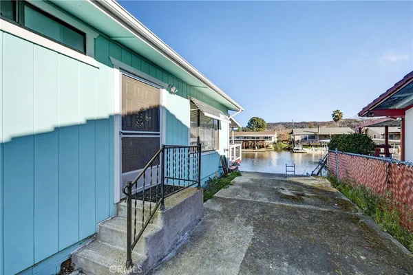 a view of a porch with wooden floor and fence