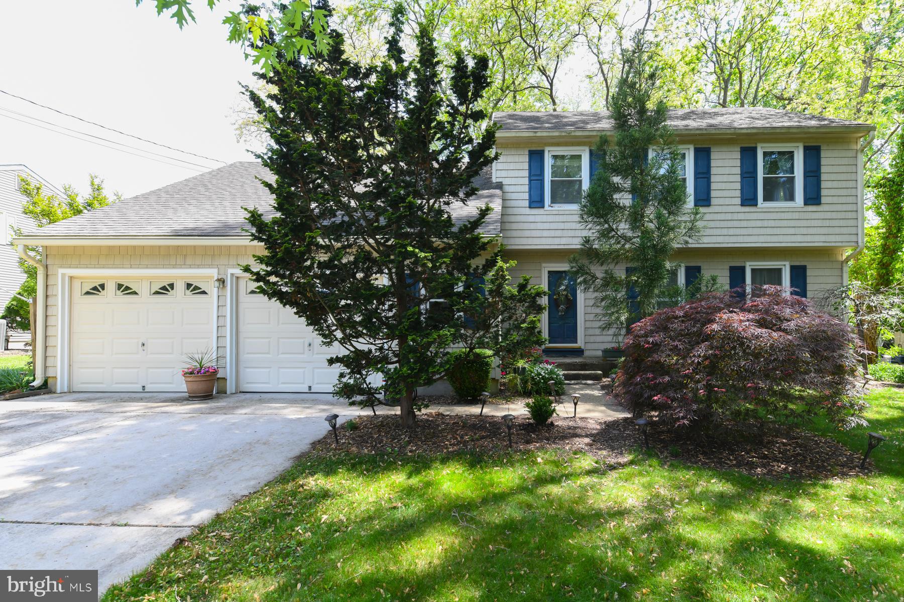 a front view of a house with a yard and a garage
