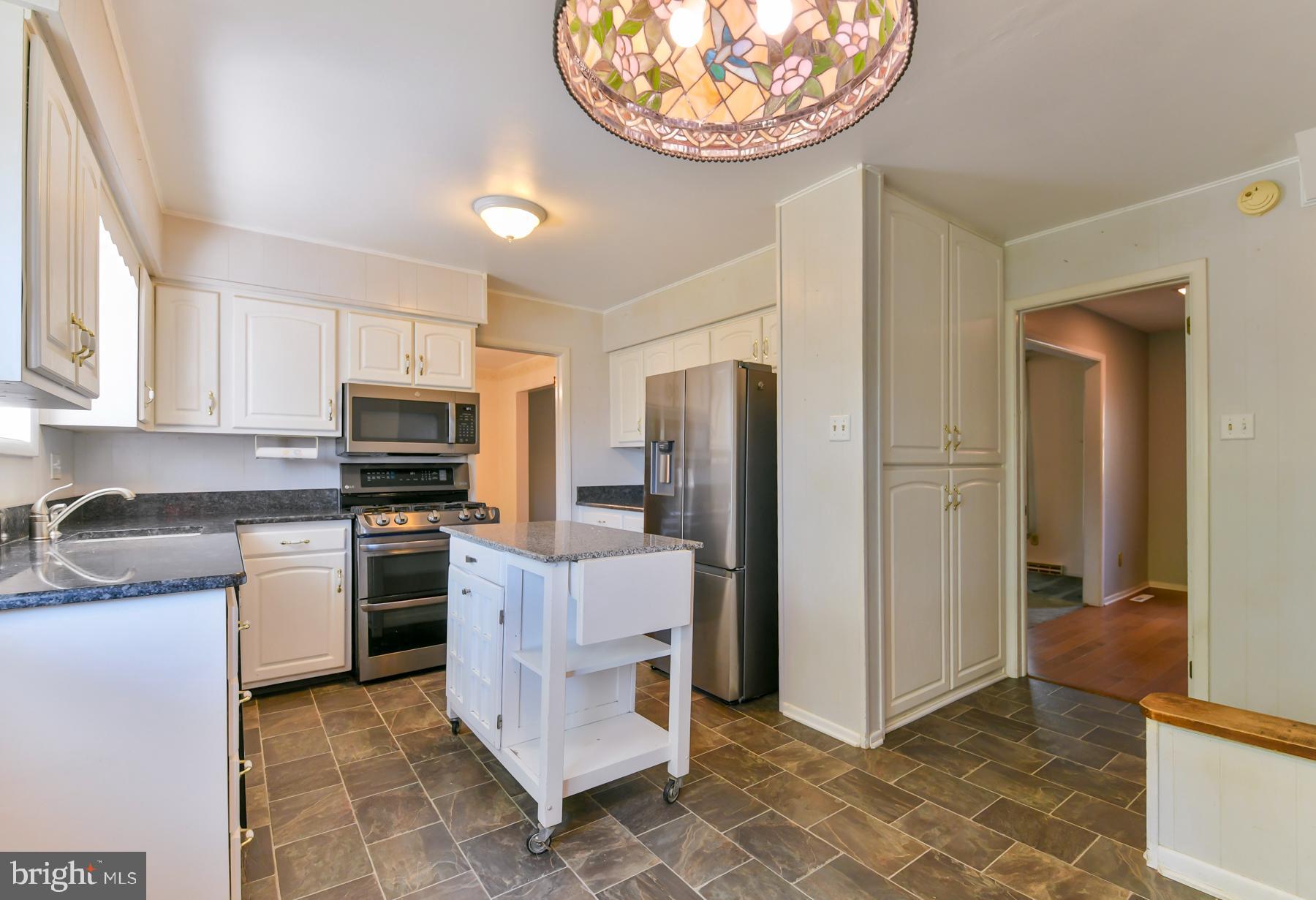 48 Sunset Drive Mount Holly, NJ 08060 - Photo 15 of 46 a kitchen with cabinets and stainless steel appliances