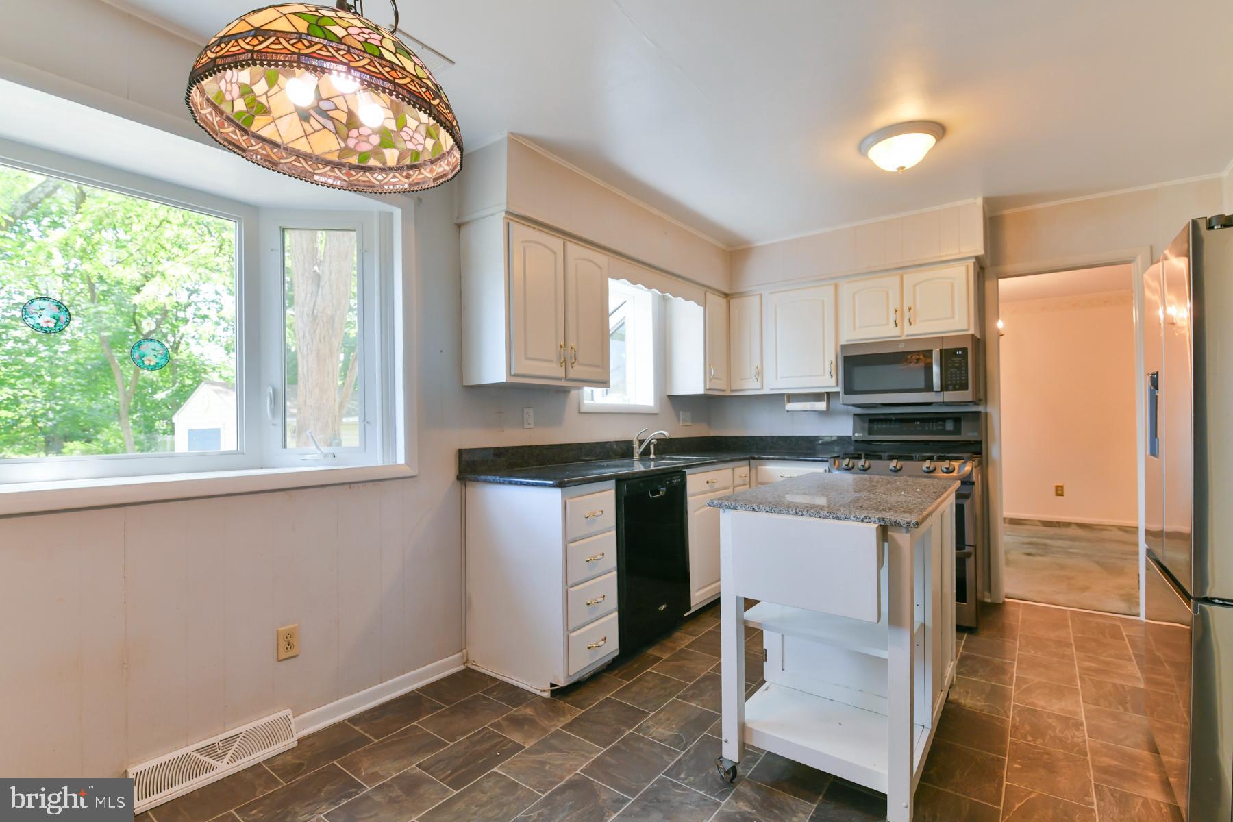 48 Sunset Drive Mount Holly, NJ 08060 - Photo 16 of 46 a kitchen with stainless steel appliances granite countertop a stove a sink and a microwave