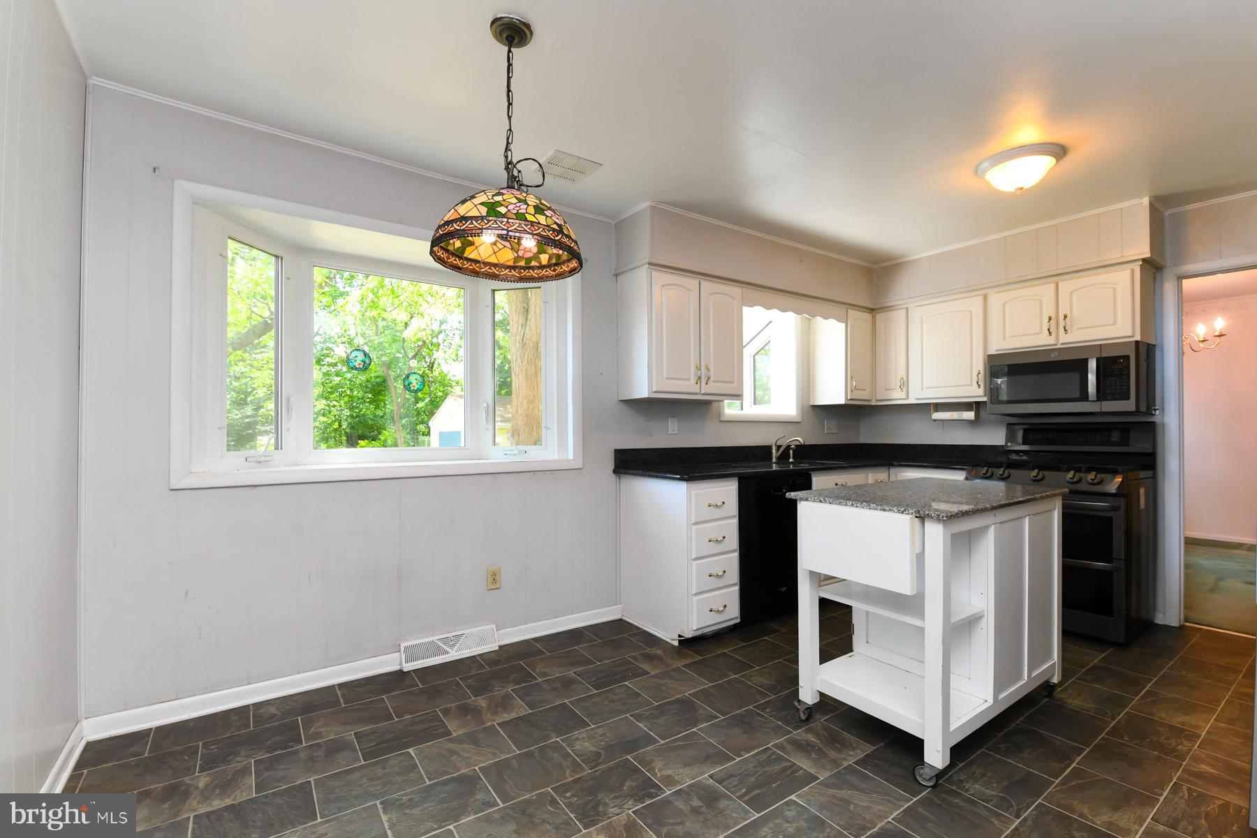 48 Sunset Drive Mount Holly, NJ 08060 - Photo 17 of 46 a kitchen with stainless steel appliances granite countertop a stove a sink and a microwave