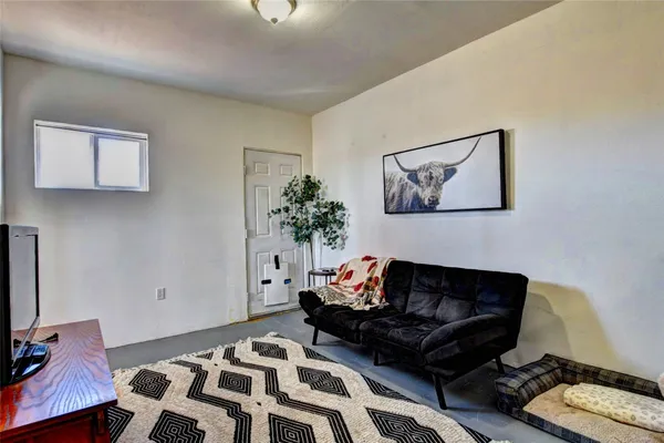 a living room with furniture and a rug
