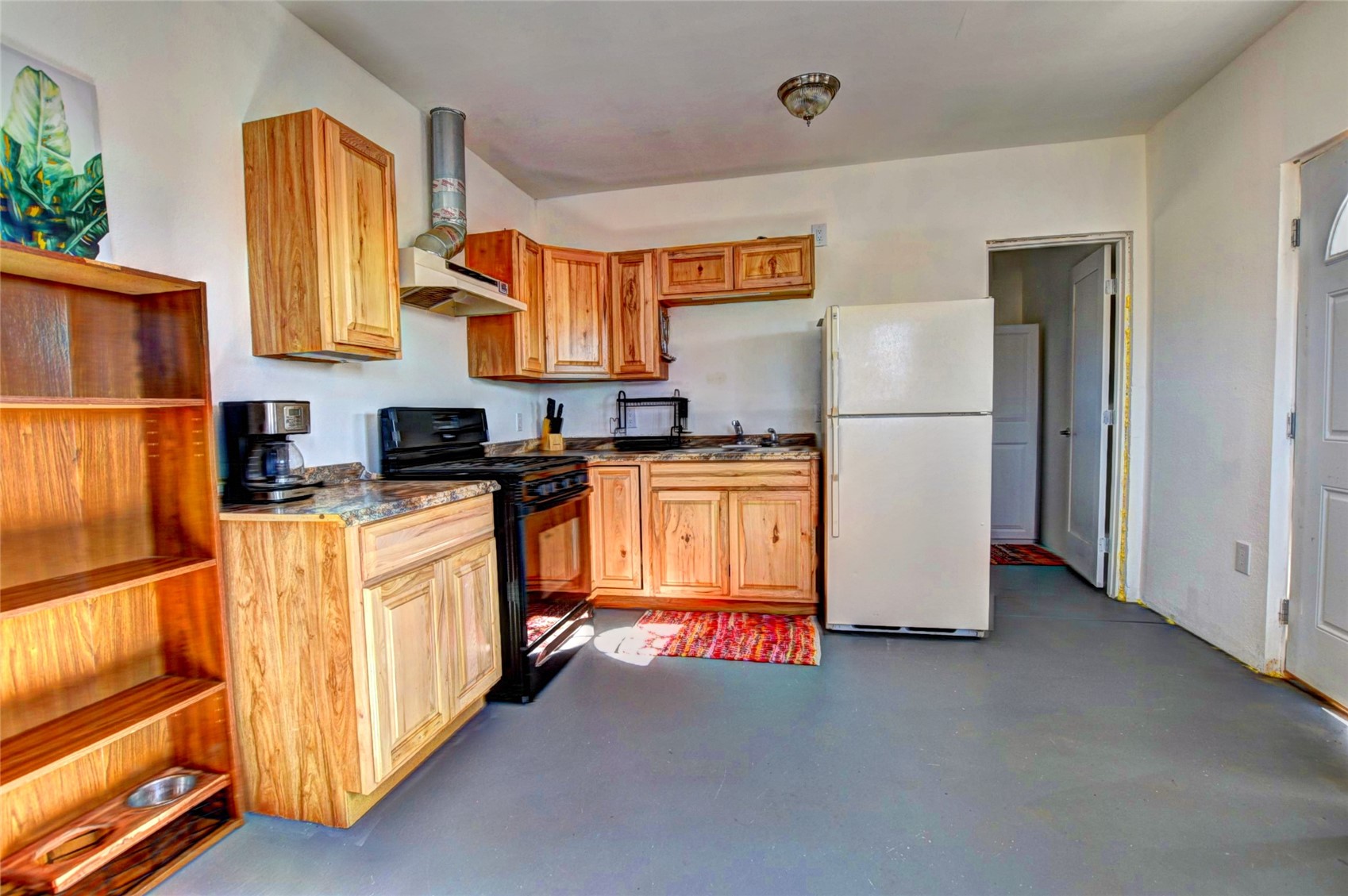 160 Rhyolite Drive Como, CO 80432 - Photo 2 of 14 a kitchen with stainless steel appliances a refrigerator a sink a stove and white cabinets