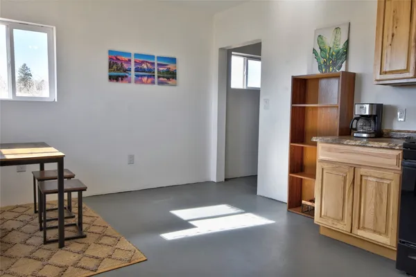 a hallway with cabinets and wooden floor