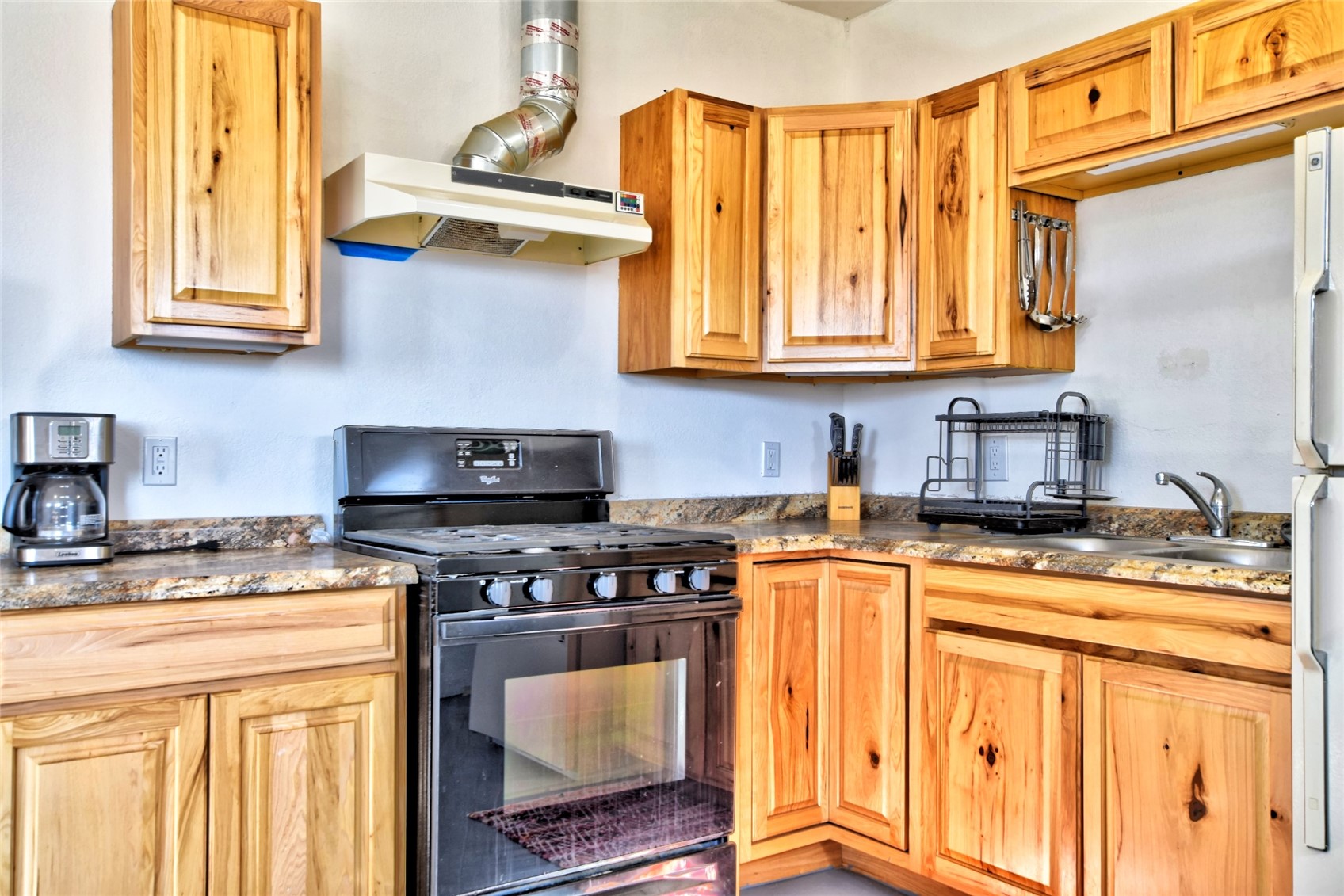 160 Rhyolite Drive Como, CO 80432 - Photo 6 of 14 a kitchen with stainless steel appliances granite countertop a stove a sink and a microwave