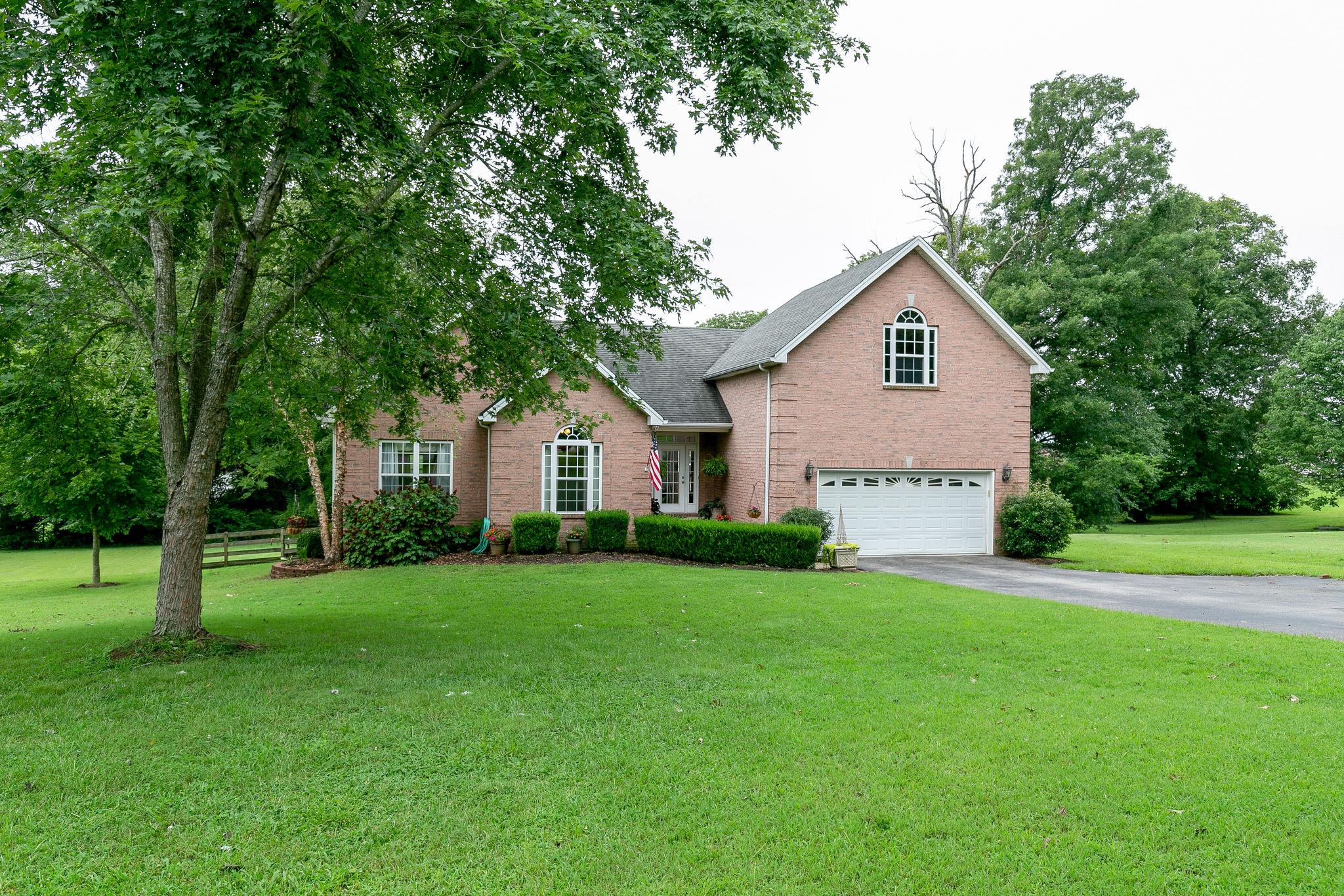 2137 Spring Lake Drive Spring Hill, TN 37174 - Photo 2 of 23 a view of a house with a big yard and large trees