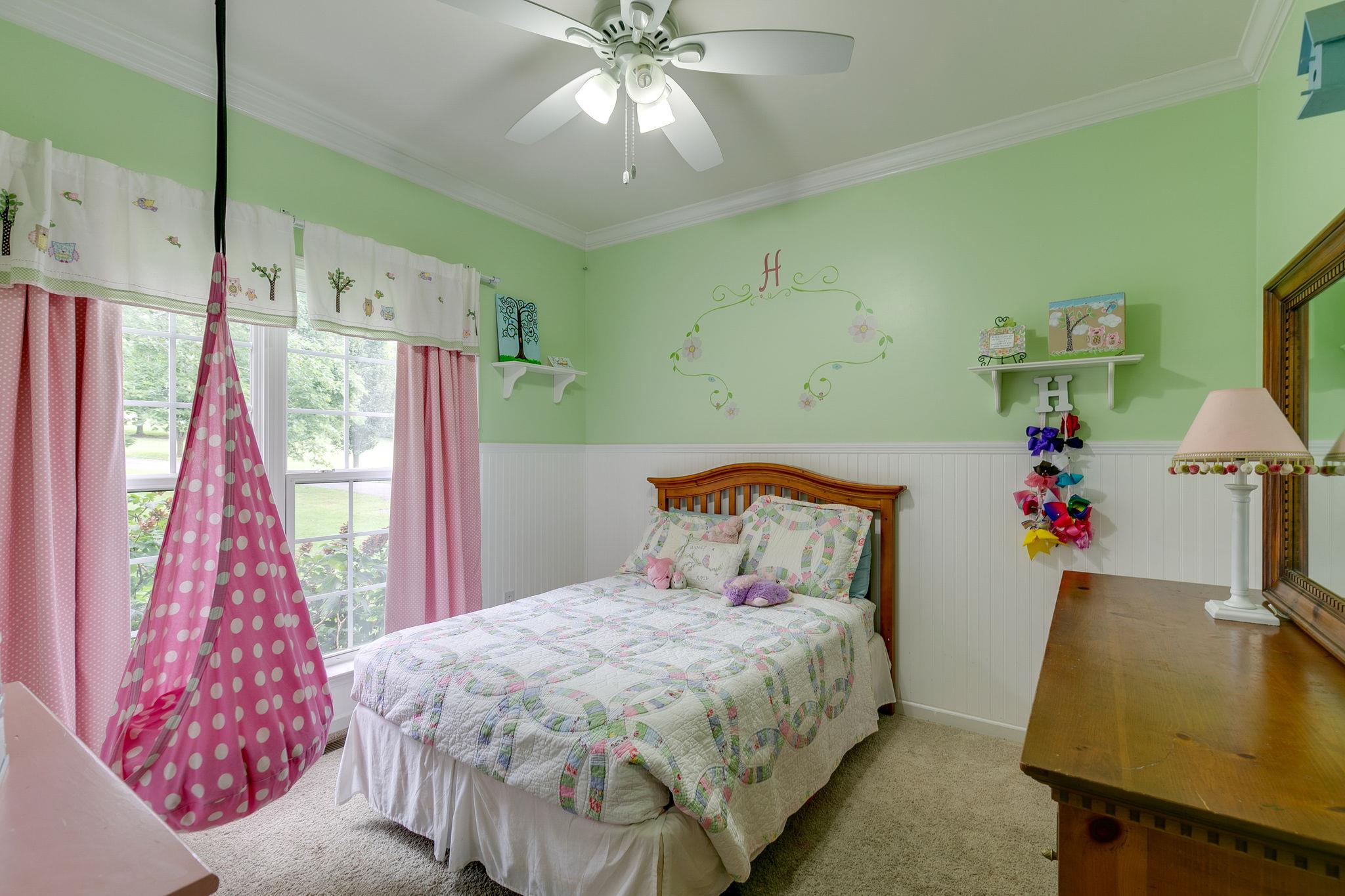 2137 Spring Lake Drive Spring Hill, TN 37174 - Photo 18 of 23 a bedroom with a bed and a chandelier