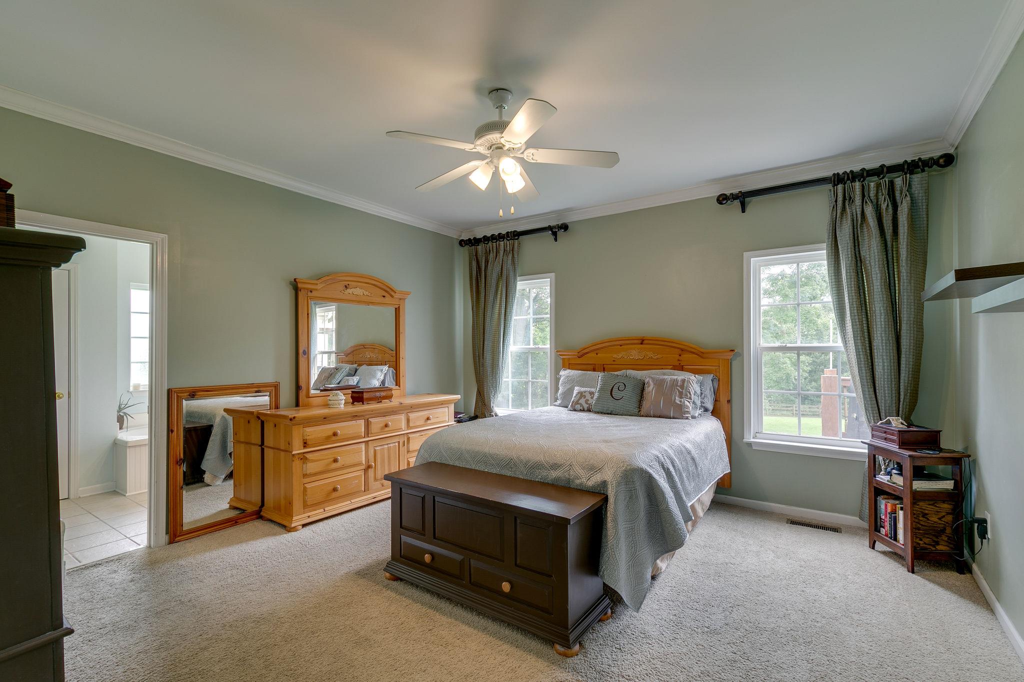 2137 Spring Lake Drive Spring Hill, TN 37174 - Photo 19 of 23 a bedroom with a bed and a chandelier