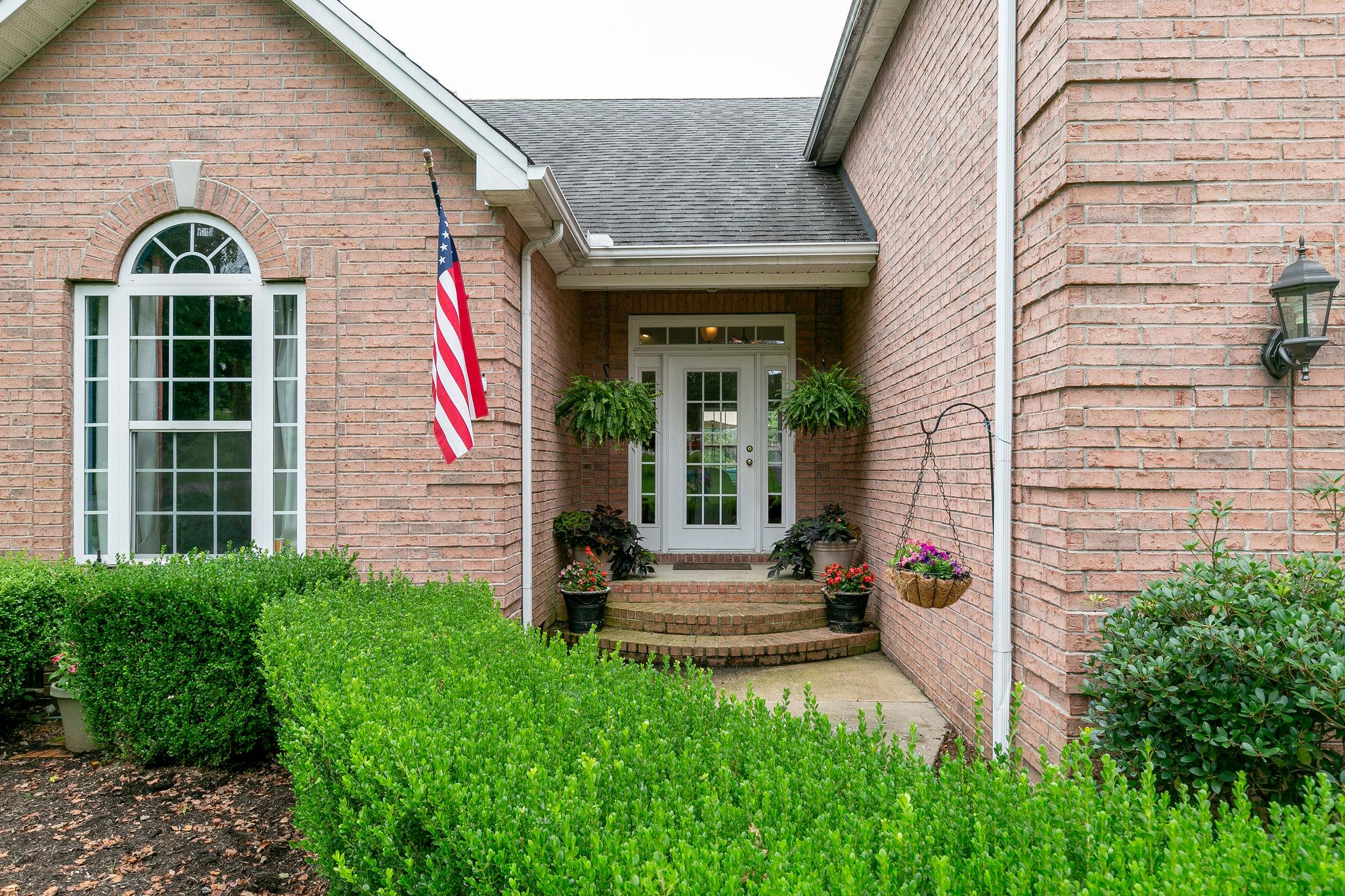 2137 Spring Lake Drive Spring Hill, TN 37174 - Photo 3 of 23 a front view of a house with garden