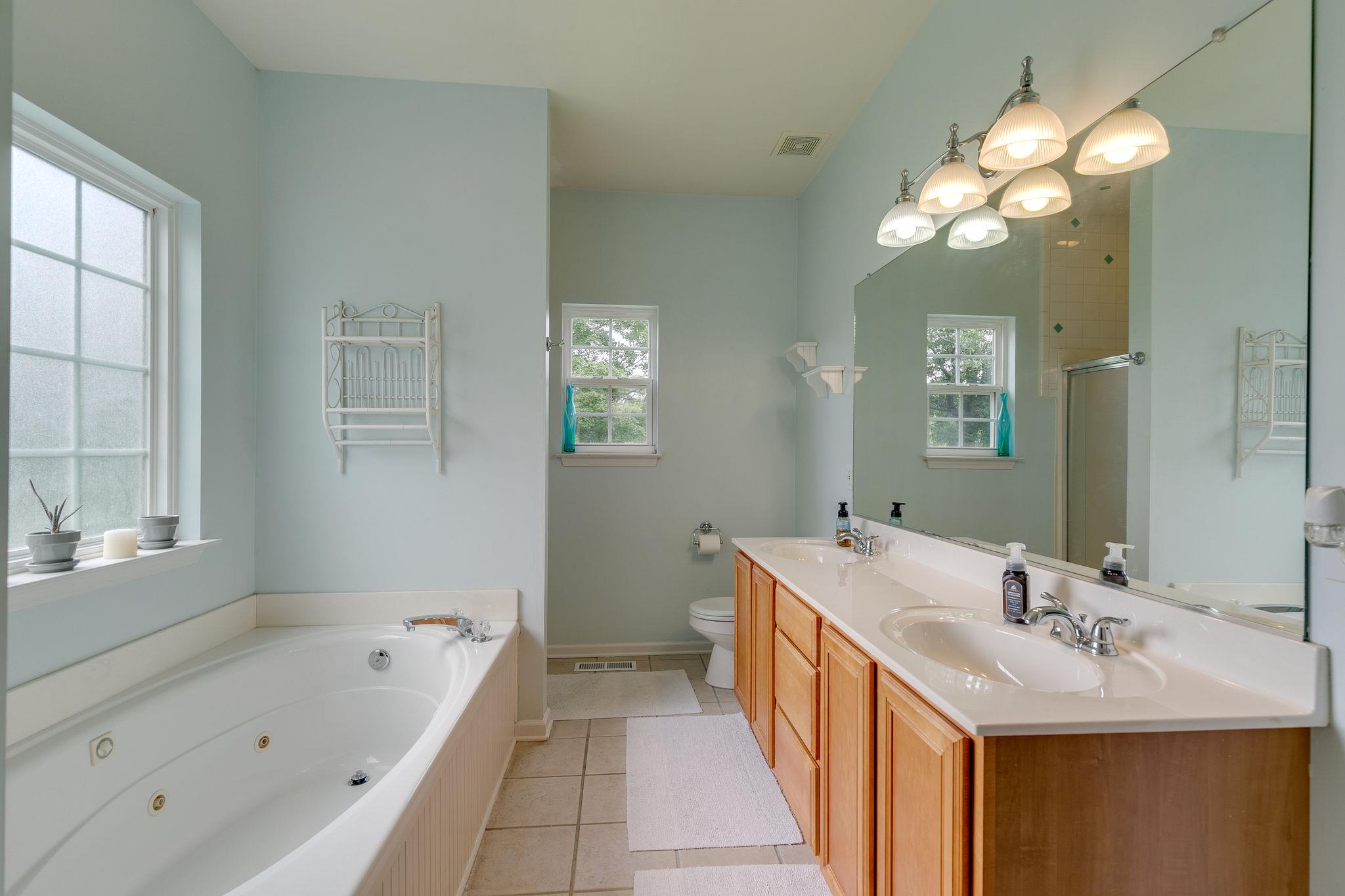 2137 Spring Lake Drive Spring Hill, TN 37174 - Photo 21 of 23 a bathroom with a tub sink and mirror