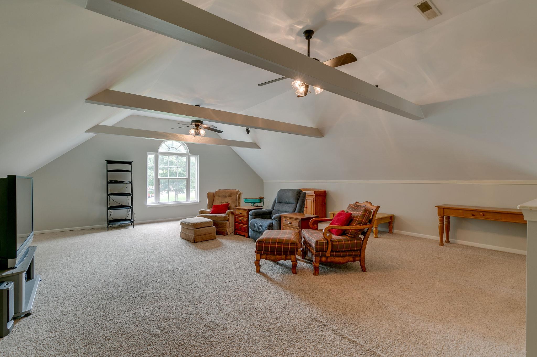 2137 Spring Lake Drive Spring Hill, TN 37174 - Photo 22 of 23 a living room with furniture and a flat screen tv