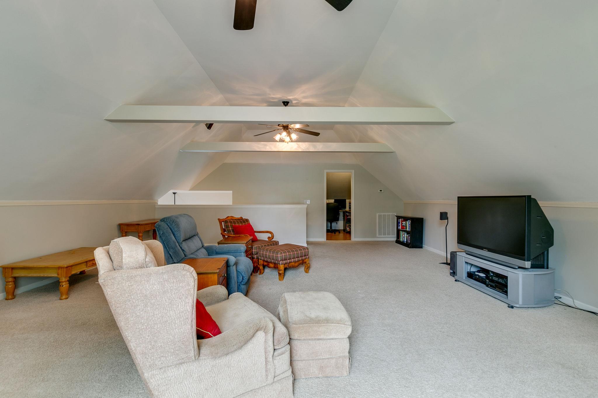 2137 Spring Lake Drive Spring Hill, TN 37174 - Photo 23 of 23 a living room with furniture and a flat screen tv