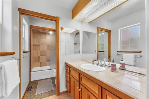 a bathroom with a sink a mirror and a shower