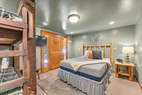 a bedroom with a large bed and a dresser