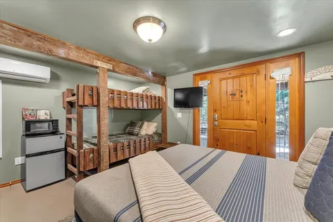 a bedroom with a bed and a large mirror