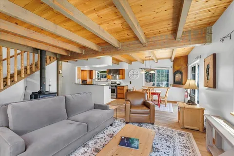 a living room with furniture and a floor to ceiling window